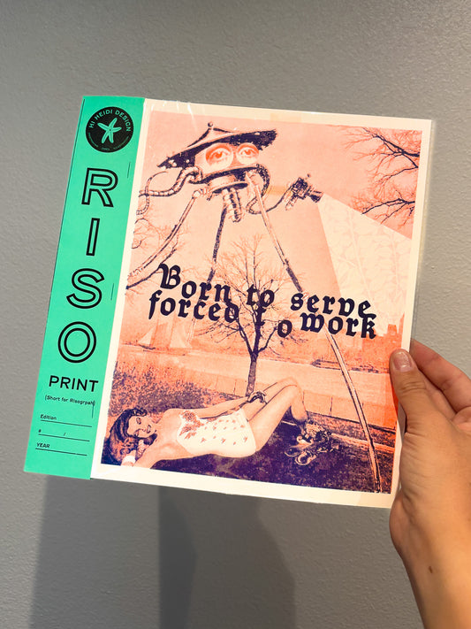 Hand holding a RISO printed book with artistic cover design against a gray background